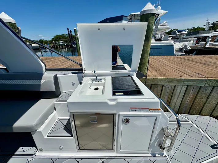  Yacht Photos Pics Outdoor kitchenette on 2025 Beneteau Gran Turismo 36 yacht, featuring sink and grill.