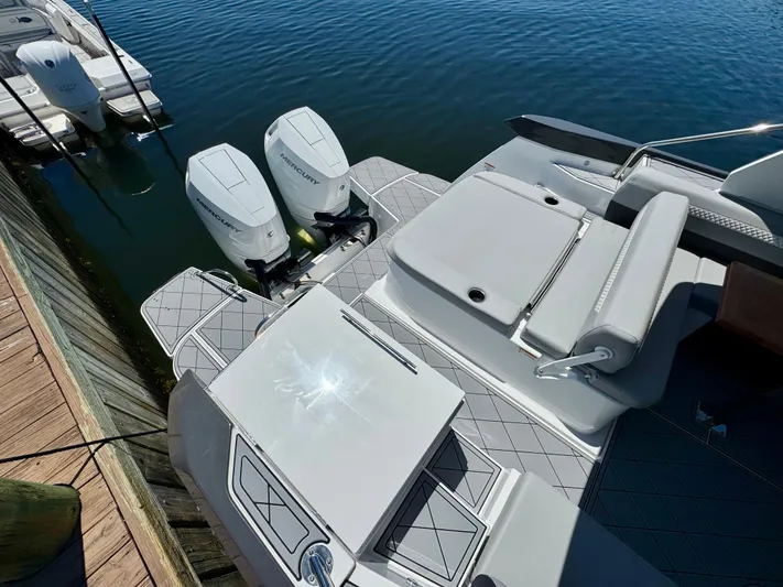  Yacht Photos Pics 2025 Beneteau Gran Turismo 36 with dual outboard engines, docked on calm water.