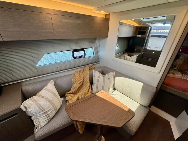  Yacht Photos Pics Luxurious interior of 2025 Beneteau Gran Turismo 36 yacht with cozy seating and modern decor.