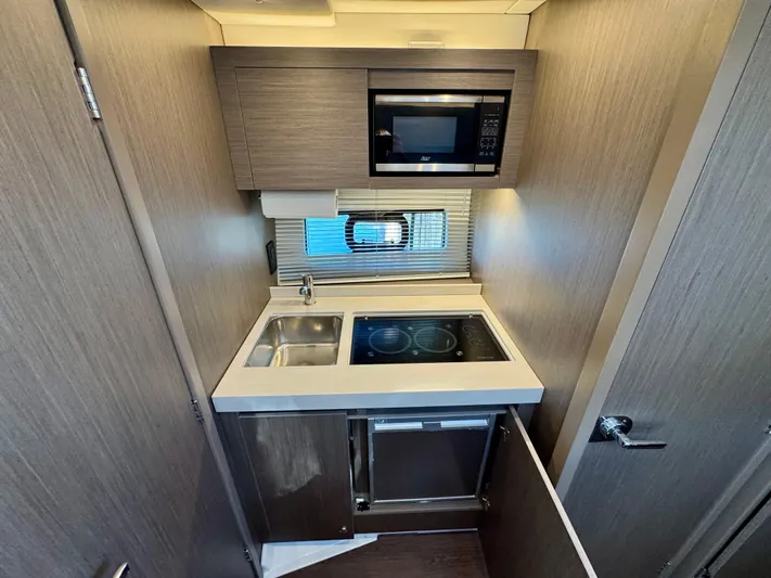  Yacht Photos Pics Compact kitchen in 2025 Beneteau Gran Turismo 36 yacht with modern appliances.
