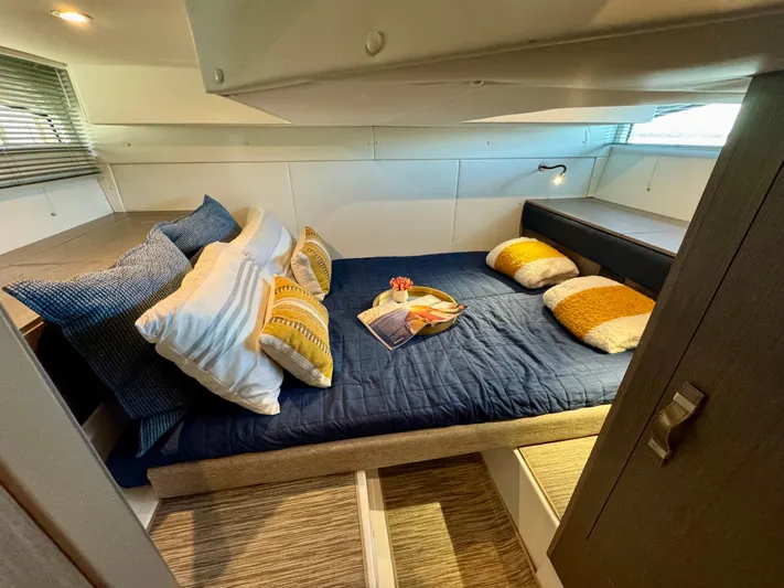  Yacht Photos Pics Cozy cabin interior of 2025 Beneteau Gran Turismo 36 with stylish bedding and cushions.