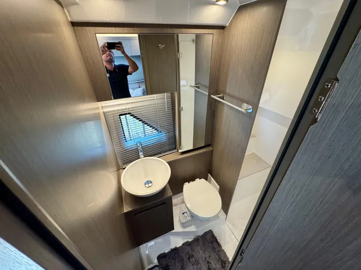 Yacht Photos Pics Bathroom interior of 2025 Beneteau Gran Turismo 36 yacht, featuring modern fixtures and wood accents.