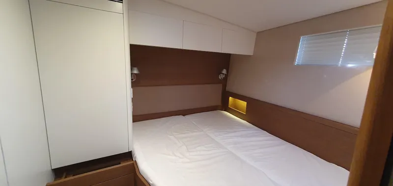 Aida II Yacht Photos Pics Luxurious bedroom interior in a 2018 CNB 66 yacht, featuring modern design and cozy lighting.