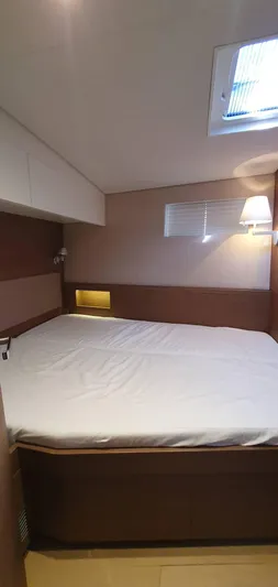 Aida II Yacht Photos Pics Luxurious cabin interior of 2018 CNB 66 yacht with cozy bed and modern lighting.