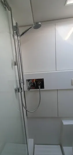 Aida II Yacht Photos Pics Modern shower area in a 2018 CNB 66 yacht with sleek fixtures and white paneling.