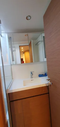 Aida II Yacht Photos Pics Modern bathroom with wooden cabinetry and sleek fixtures on a CNB 66 yacht, 2018 model.