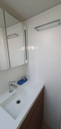 Aida II Yacht Photos Pics Modern bathroom with sleek sink, mirrored cabinet, and minimalist design in a 2018 CNB 66 model.