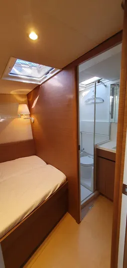 Aida II Yacht Photos Pics Luxurious cabin interior of 2018 CNB 66 yacht with bed and ensuite bathroom.