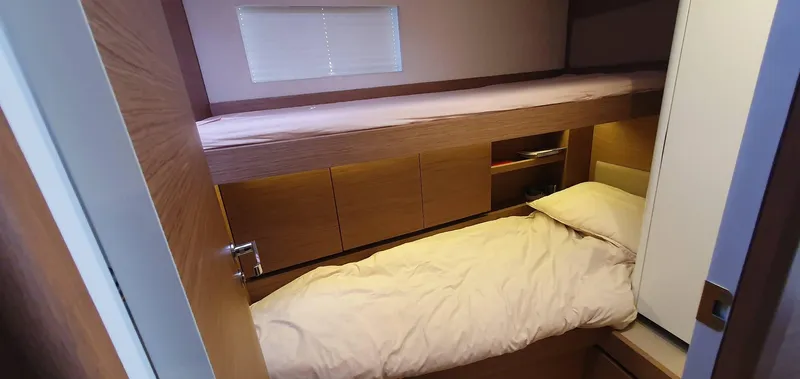 Aida II Yacht Photos Pics Compact cabin interior with bunk beds in a 2018 CNB 66 yacht.