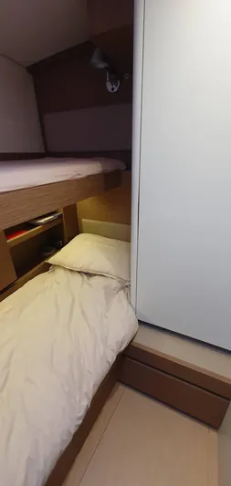 Aida II Yacht Photos Pics Compact cabin interior of 2018 CNB 66 yacht with cozy bedding.