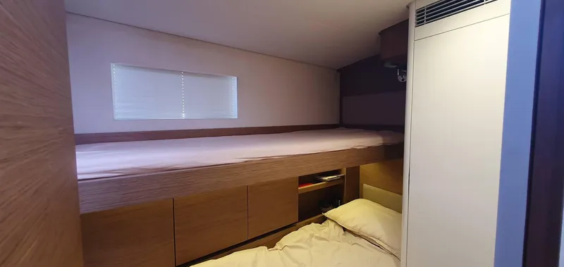 Aida II Yacht Photos Pics Compact cabin interior with bunk beds in a 2018 CNB 66 yacht.