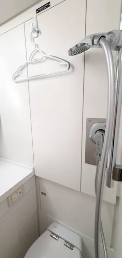 Aida II Yacht Photos Pics Modern bathroom with shower, toilet, and hanger in a 2018 CNB 66 model.