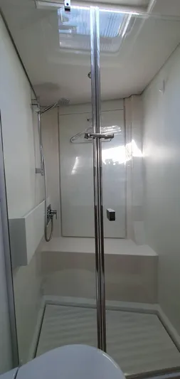 Aida II Yacht Photos Pics Modern shower cabin in a 2018 CNB 66 yacht, featuring sleek design and chrome fixtures.