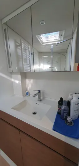 Aida II Yacht Photos Pics Modern bathroom vanity with mirror, sink, and toiletries on a CNB 66 yacht, 2018 model.