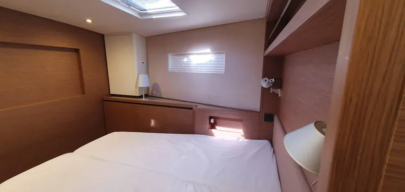 Aida II Yacht Photos Pics Cozy bedroom interior on 2018 CNB 66 yacht with natural light and modern design.