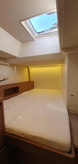 Aida II Yacht Photos Pics Luxurious cabin interior of 2018 CNB 66 yacht with skylight and ambient lighting.