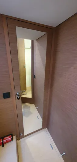 Aida II Yacht Photos Pics Modern yacht interior with wooden paneling and full-length mirror, CNB 66, 2018 model.