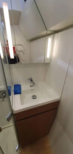 Aida II Yacht Photos Pics Compact bathroom sink area in a 2018 CNB 66 yacht, featuring modern fixtures and mirrored cabinet.