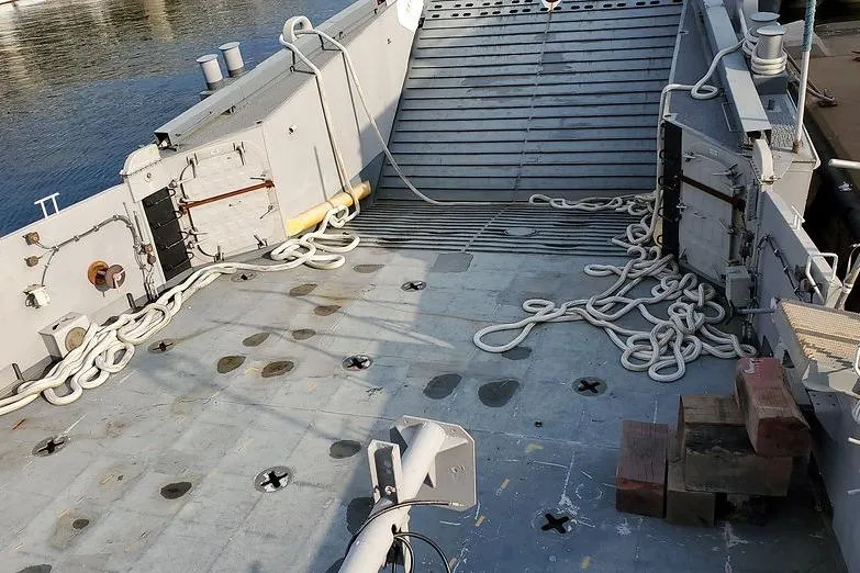  Yacht Photos Pics 1970 COMMERICAL BOAT LCU-135 deck with ropes and equipment, docked by water.