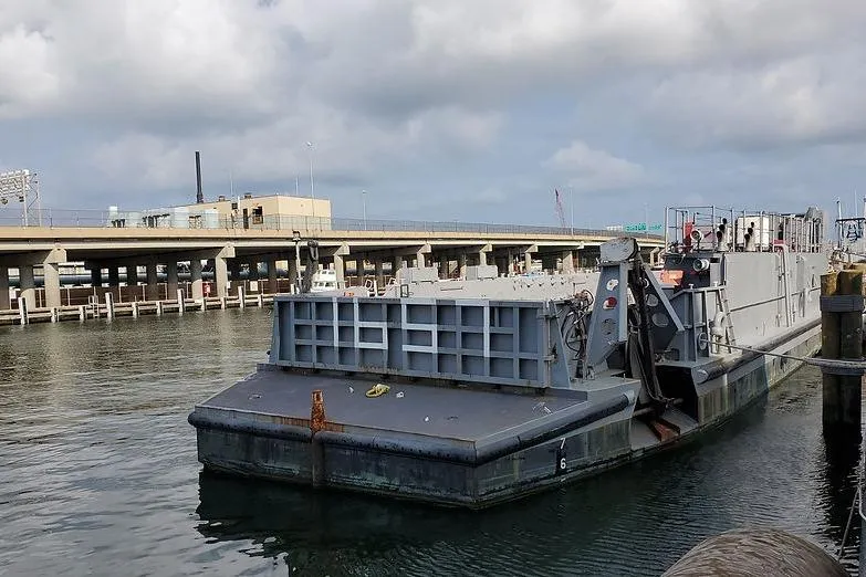  Yacht Photos Pics 1970 COMMERICAL BOAT LCU-135 docked at a harbor under cloudy skies.