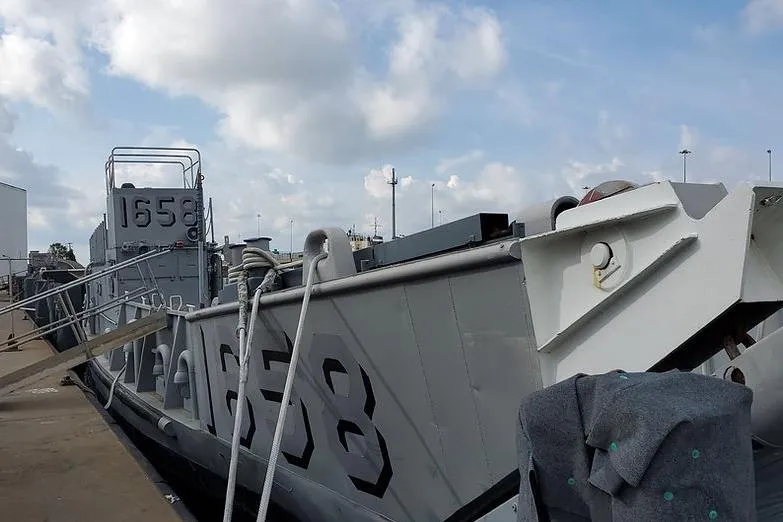  Yacht Photos Pics 1970 COMMERICAL BOAT LCU-135 docked, displaying hull number 1658 under cloudy sky.
