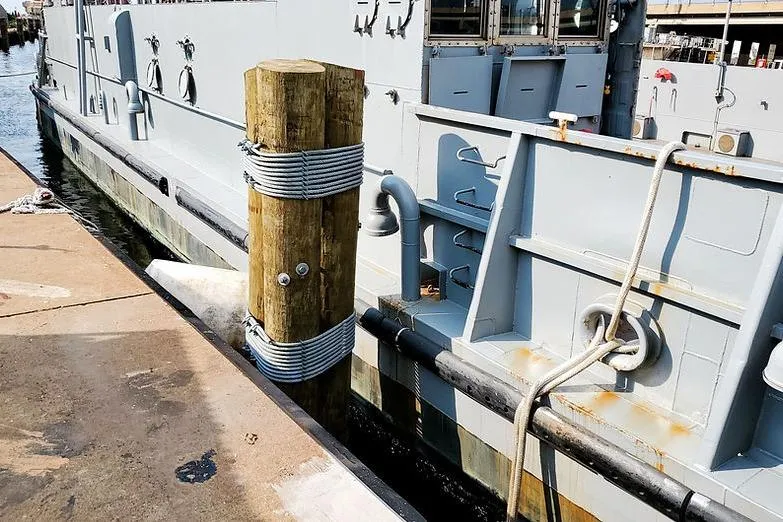  Yacht Photos Pics 1970 COMMERICAL BOAT LCU-135 docked, showing side view with mooring post.