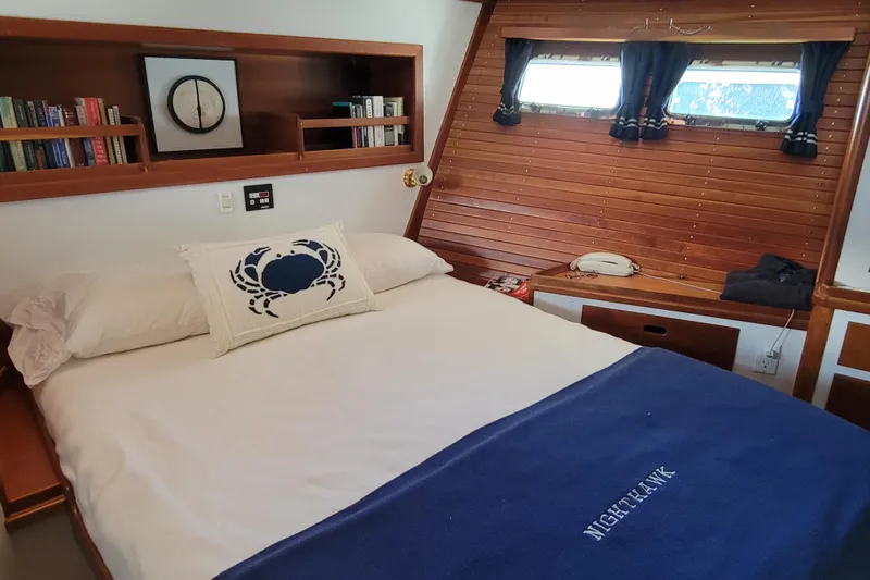 Nighthawk Yacht Photos Pics Cozy bedroom in 1999 Lyman-Morse pilothouse with nautical decor and wooden accents.