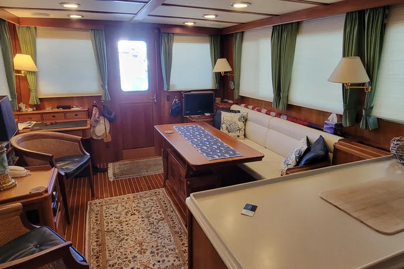Nighthawk Yacht Photos Pics Luxurious 1999 Lyman-Morse pilothouse interior with elegant wood finishes and comfortable seating.