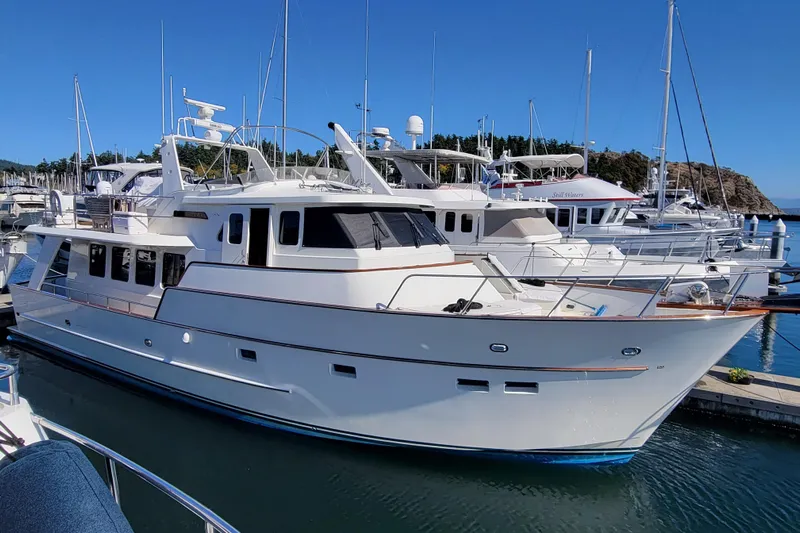 Nighthawk Yacht Photos Pics 1999 Lyman-Morse pilothouse yacht docked in a marina under clear blue skies.