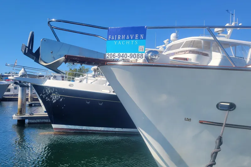 Nighthawk Yacht Photos Pics 1999 Lyman-Morse pilothouse yacht docked at marina, Fairhaven Yachts sign visible.