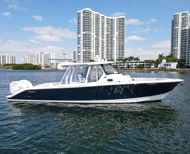  Yacht Photos Pics 2022 Pursuit S 358 Sport boat on water with city skyline background.