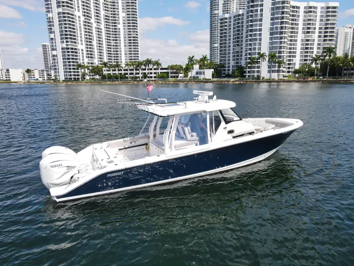  Yacht Photos Pics 2022 Pursuit S 358 Sport boat on water with city skyline background.