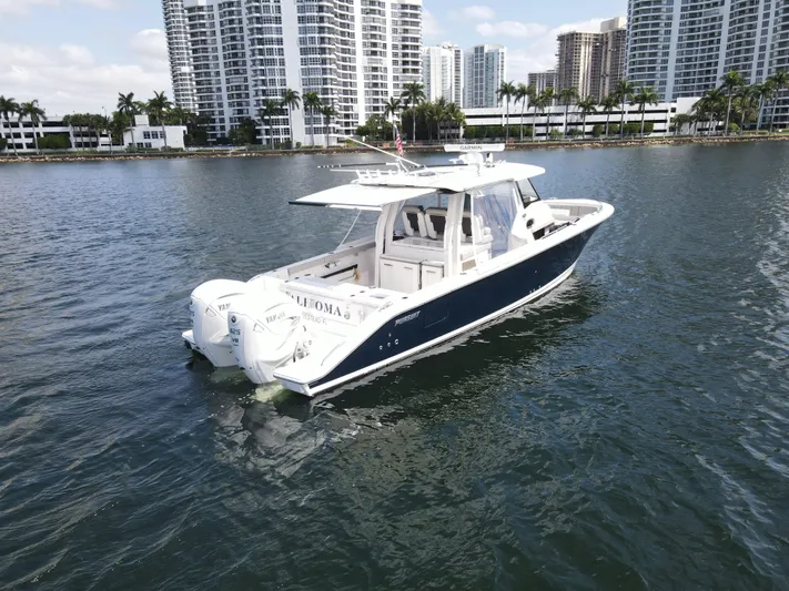  Yacht Photos Pics 2022 Pursuit S 358 Sport boat on water with city skyline background.