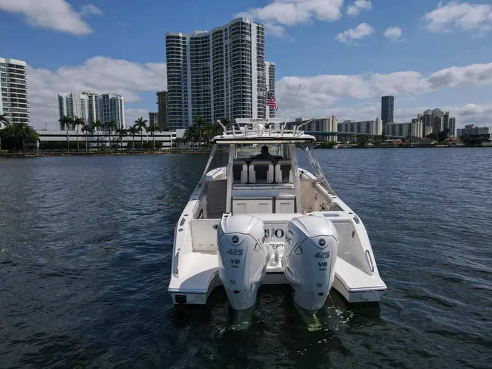  Yacht Photos Pics 2022 Pursuit S 358 Sport boat on water with city skyline background.
