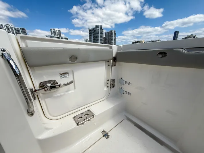 Yacht Photos Pics 2022 Pursuit S 358 Sport boat interior with city skyline and blue sky background.