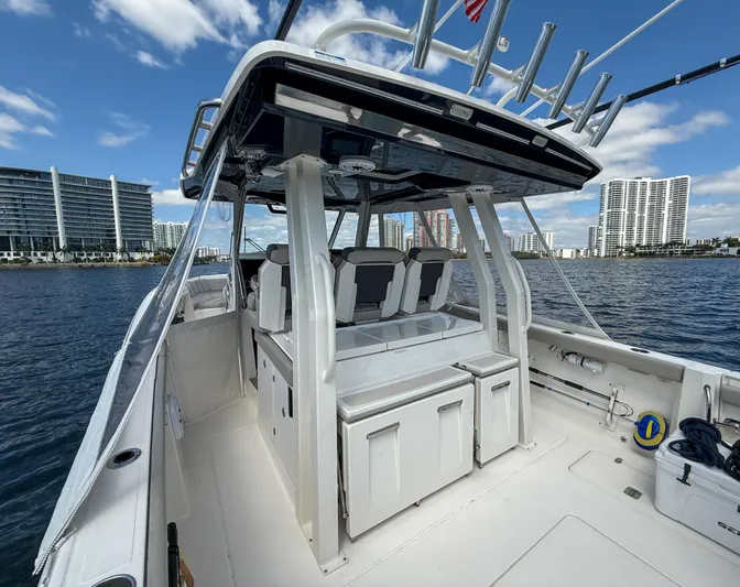  Yacht Photos Pics 2022 Pursuit S 358 Sport boat on water, modern design, city skyline background.