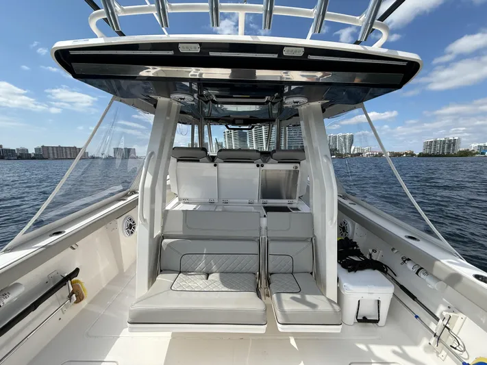  Yacht Photos Pics 2022 Pursuit S 358 Sport boat interior with seating, on a sunny day.