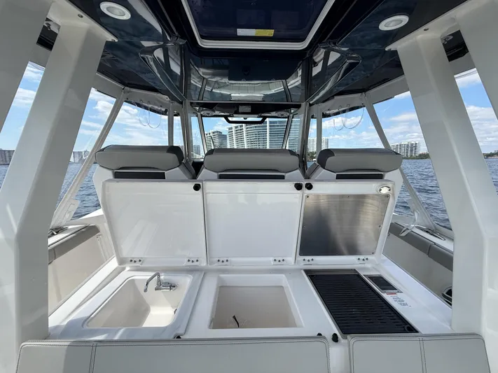  Yacht Photos Pics 2022 Pursuit S 358 Sport boat interior with seating and amenities on open water.