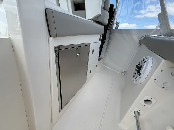  Yacht Photos Pics 2022 Pursuit S 358 Sport boat interior with stainless steel storage and speaker.