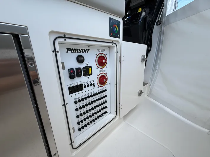  Yacht Photos Pics 2022 Pursuit S 358 Sport control panel with switches and dials in a sleek design.