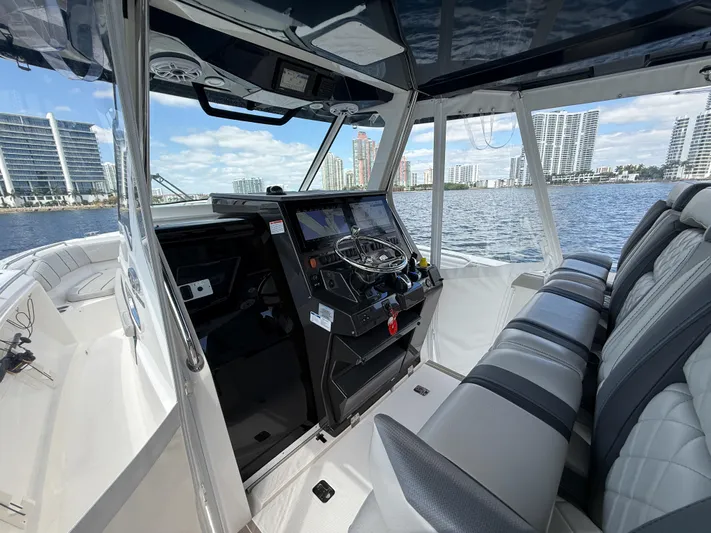  Yacht Photos Pics Interior view of 2022 Pursuit S 358 Sport boat with modern dashboard and seating.
