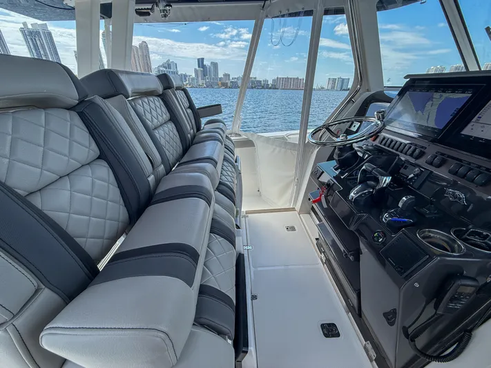  Yacht Photos Pics 2022 Pursuit S 358 Sport boat interior with luxurious seating and advanced control panel.