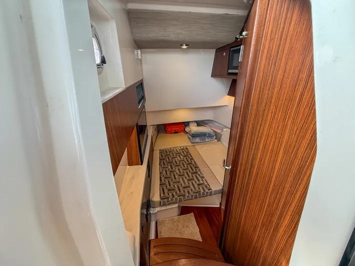  Yacht Photos Pics 2022 Pursuit S 358 Sport cabin interior with wood finish and modern amenities.
