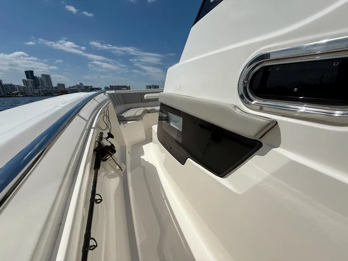  Yacht Photos Pics 2022 Pursuit S 358 Sport boat deck with city skyline in background.