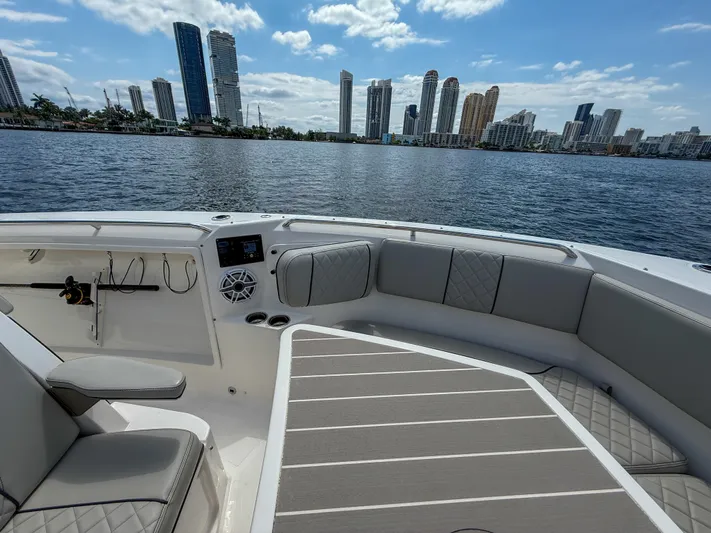 Yacht Photos Pics 2022 Pursuit S 358 Sport boat interior with city skyline in the background.