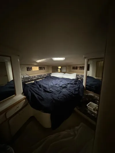 Deja Vue Yacht Photos Pics Cozy cabin interior of 1995 Sea Ray 500 yacht with bed and storage.