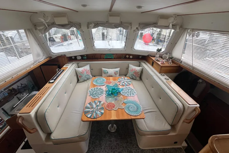  Yacht Photos Pics Cozy interior of 2004 PDQ Passage Maker with elegant dining area and decorative accents.