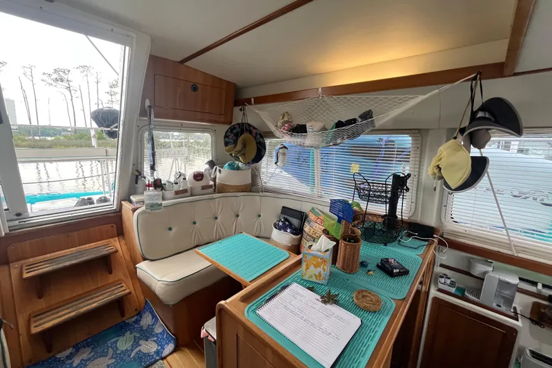  Yacht Photos Pics Interior of 2004 PDQ Passage Maker boat with cozy seating and nautical decor.