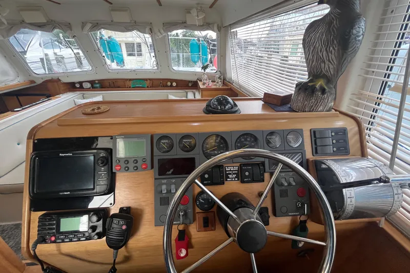  Yacht Photos Pics 2004 PDQ Passage Maker helm with navigation instruments and decorative eagle statue.