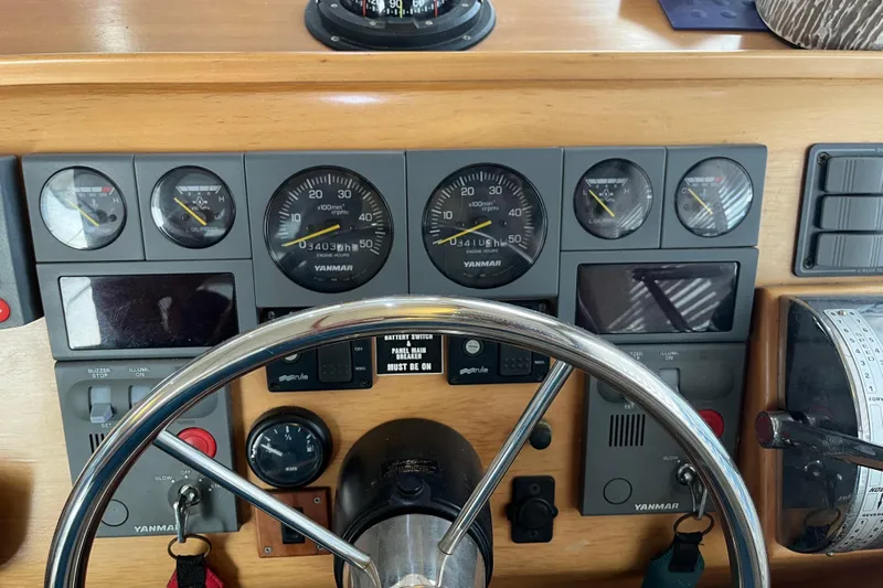  Yacht Photos Pics Control panel of a 2004 PDQ Passage Maker boat with Yanmar gauges and steering wheel.